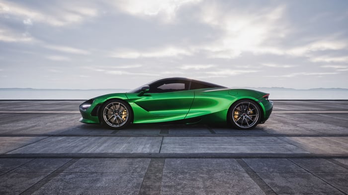 Green McLaren 720s parked on a concrete surface