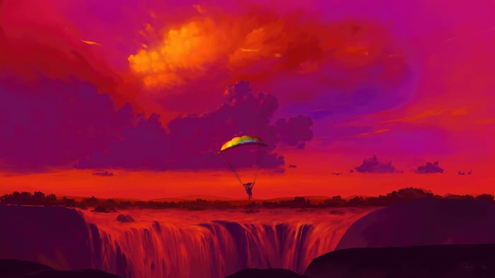 Paraglider over a waterfall at sunset