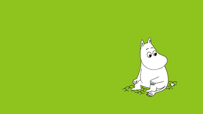 Moomin sitting on green grass