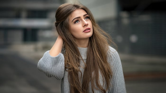 Girl in a grey sweater looking up