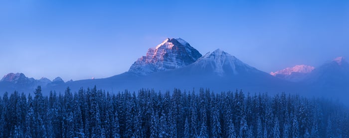 Snowy mountains in Alberta, Canada with mist
