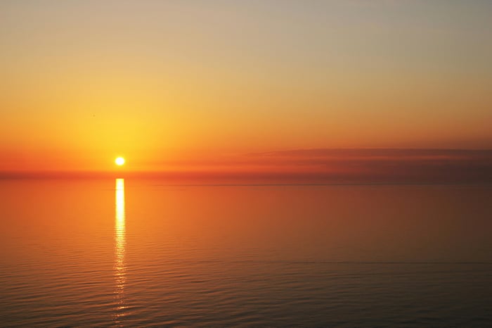 Calm Body Of Water During Sunset