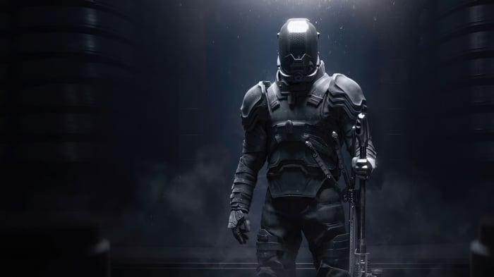 Soldier in futuristic armor holding a rifle