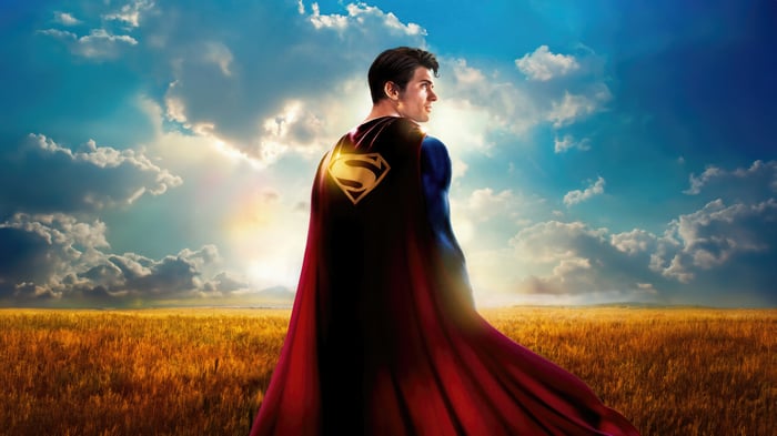 Superman in a field with a rainbow
