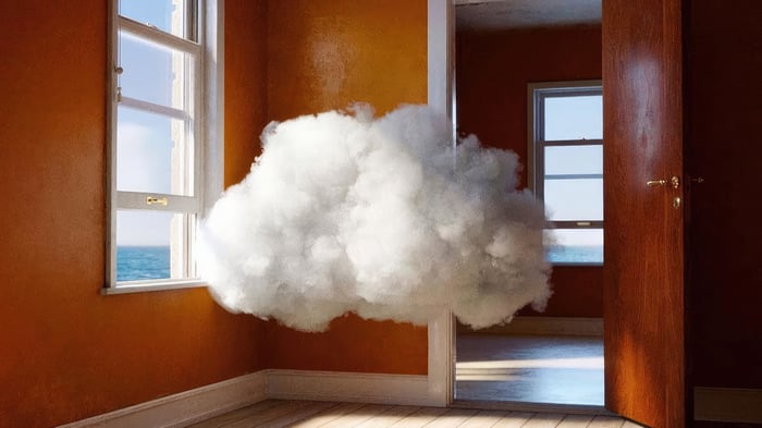 Cloud floating in a room with a view of the ocean