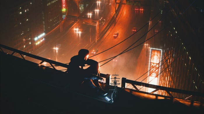 Man looking at cyber city at night