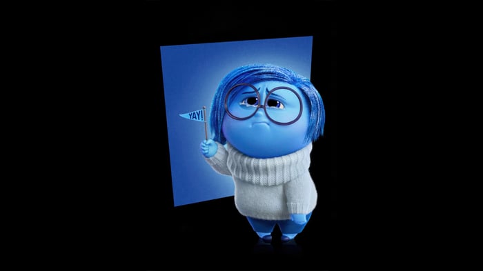 Sadness from Inside Out holding a "YAY!" flag