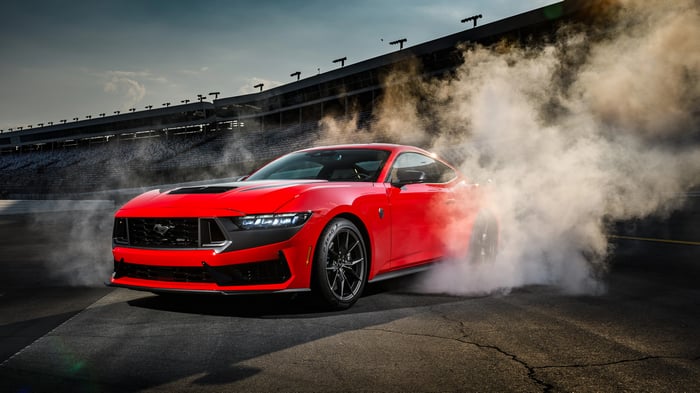 Red Ford Mustang Dark Horse doing a burnout