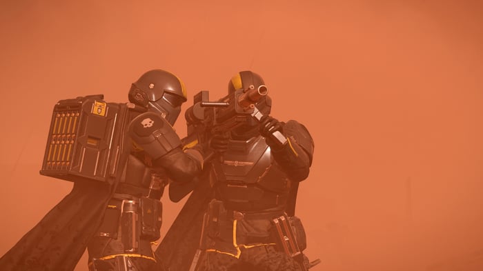 Helldivers 2 soldiers aiming weapons on a dusty planet
