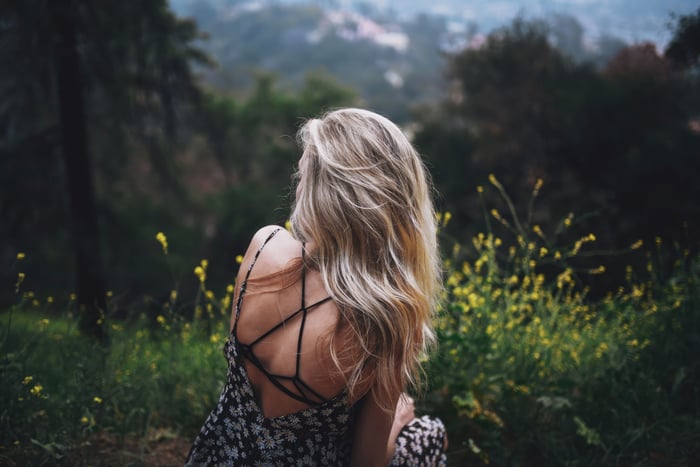 Woman with long blonde hair in a floral dress