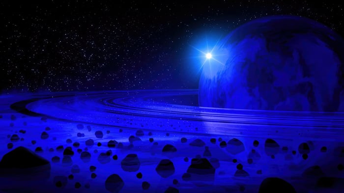 Blue planet with rings and asteroids in space