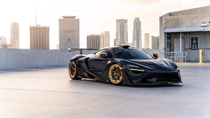 Black McLaren 720S with gold rims on rooftop