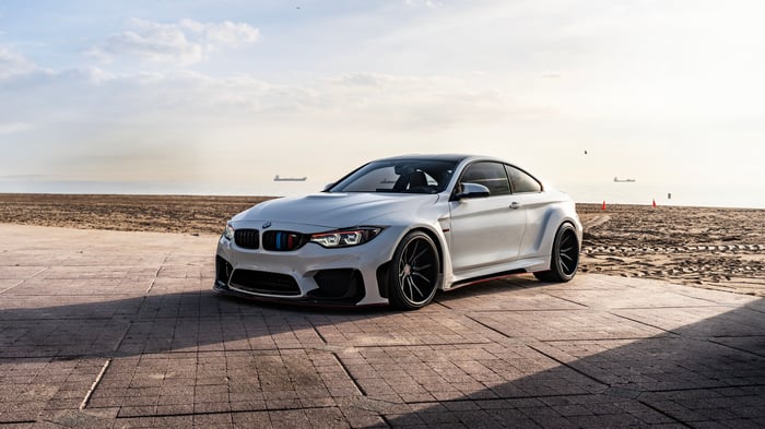 White BMW M4 Widebody on a Beach