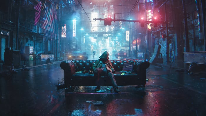 Person sitting on a couch in a rainy cyberpunk city