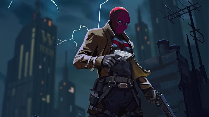 Red Hood stands with guns in a city at night