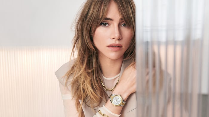 Suki Waterhouse wearing a watch and necklace