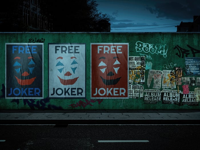 Joker posters on a graffiti-covered wall