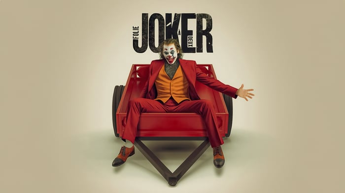 Joker sitting in a red cart with "Folie à Deux" title
