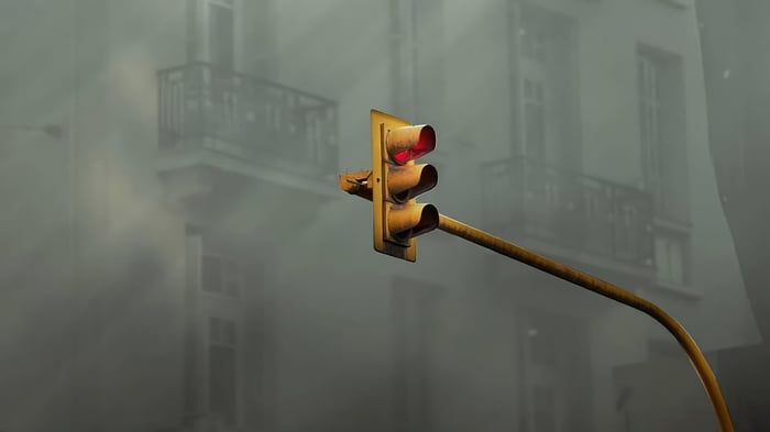 Traffic light in fog with building