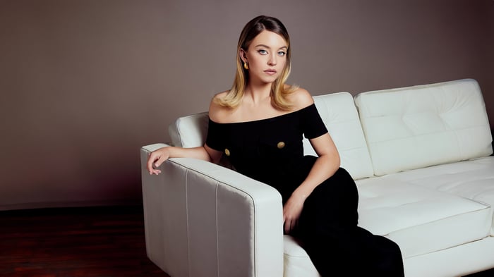 Sydney Sweeney on a white couch