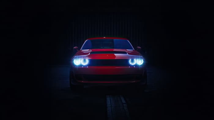 Red Dodge Challenger with glowing headlights
