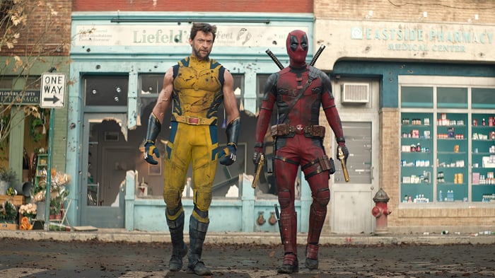 Deadpool and Wolverine walk down a street