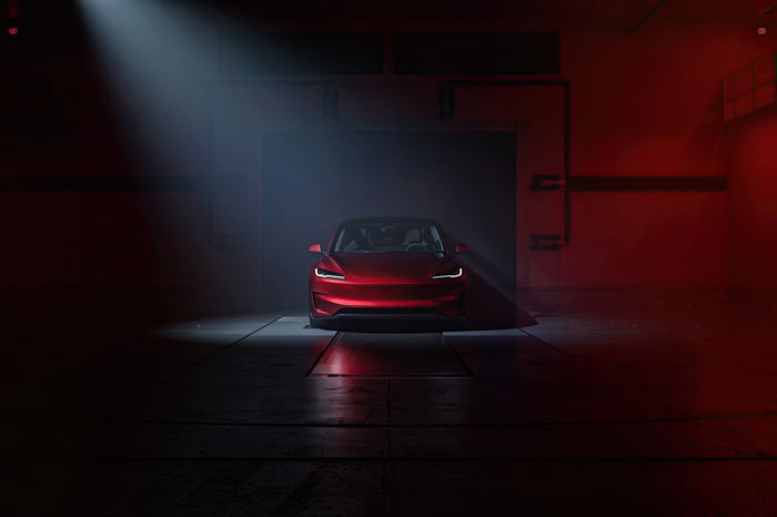 Red Tesla Model 3 Performance 2024 in a dark garage