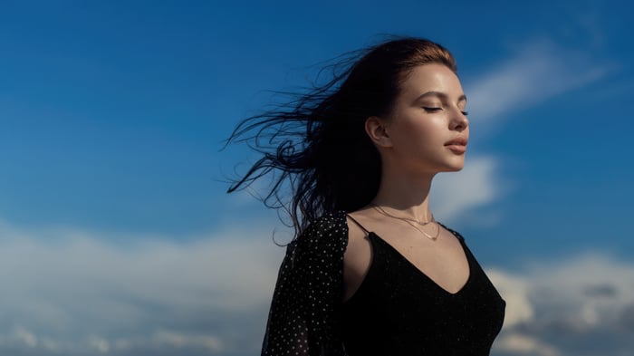 Girl feeling the wind outdoors with closed eyes