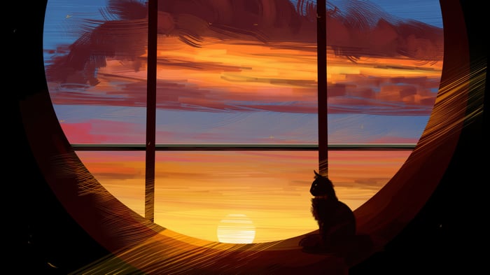 Cat looking at the sunset through a round window