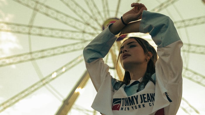 Girl in front of a Ferris wheel