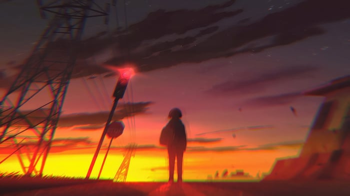 Silhouette of a person against a vibrant sunset