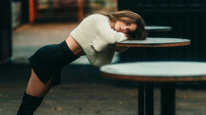 Girl leaning on a table lost in thought
