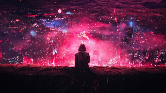 Person watching a vibrant, glowing city at night
