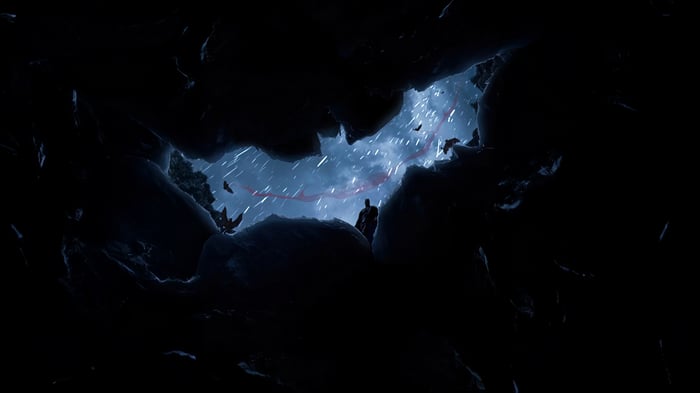 Batman in a cave during a storm