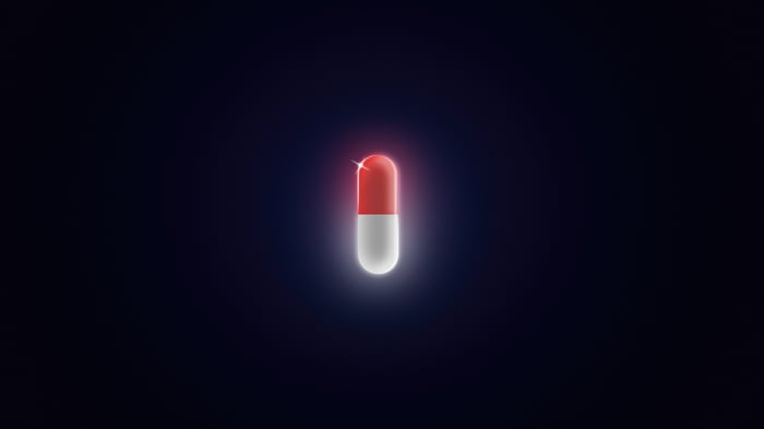 Red and white pill on dark background