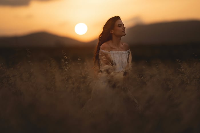 Girl in a field at sunset