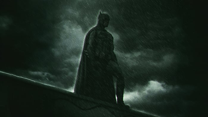 Batman Standing on a Rooftop in the Rain