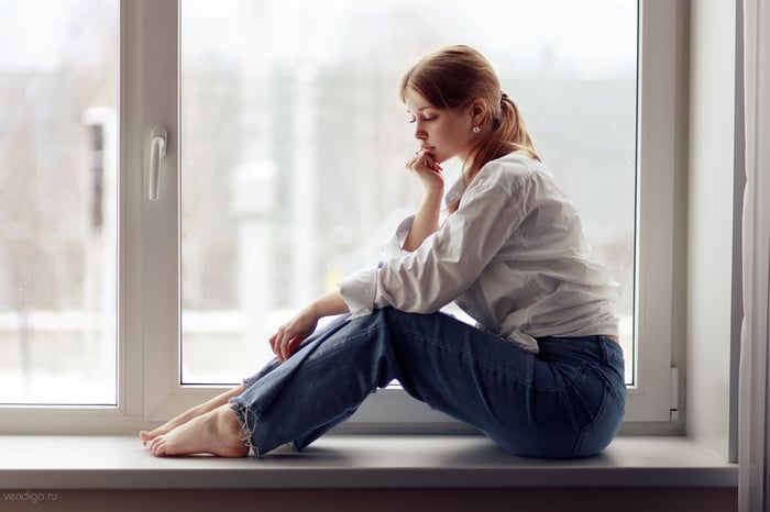 Girl Sitting By The Window