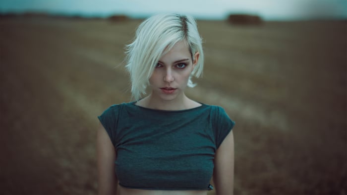 Woman with short white hair in a field