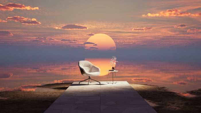 Armchair and side table on a platform at sunset