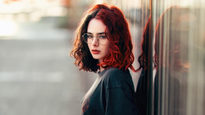Girl with red and dark hair wearing glasses