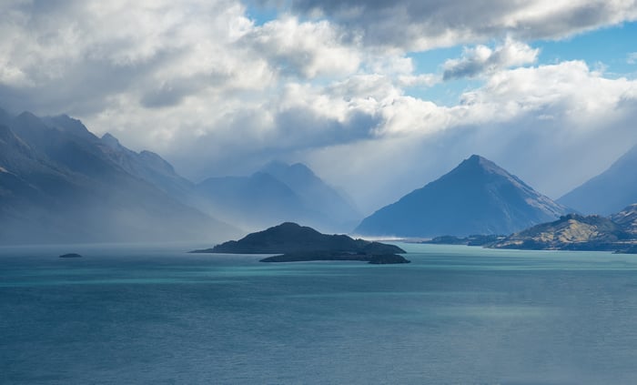 Lake with Mountains Under Stormy Sky