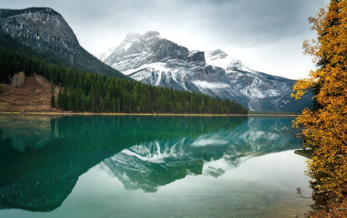 Emerald Lake with Snow-Capped Mountains and Autumn Trees