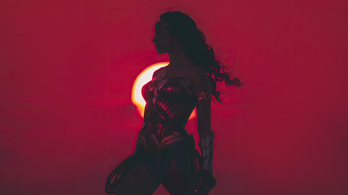 Wonder Woman silhouetted against a red sun
