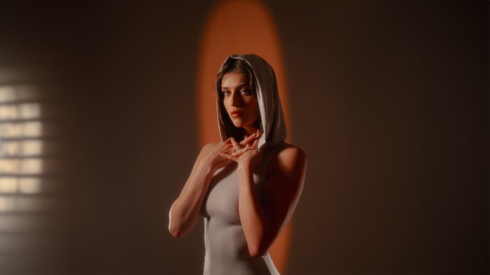Woman in a hooded dress with dramatic lighting