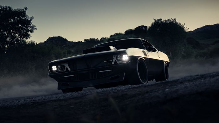 440ci Plymouth Barracuda driving on a dirt road