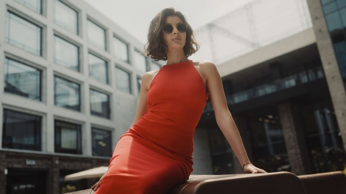Woman in red dress and sunglasses outdoors