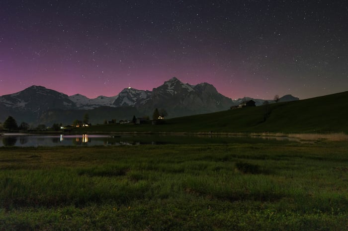 Mountain lake under a starry night sky