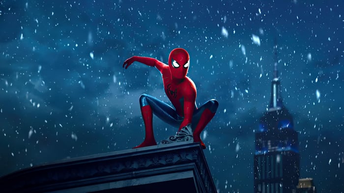 Spider-Man crouches on a rooftop in the snow