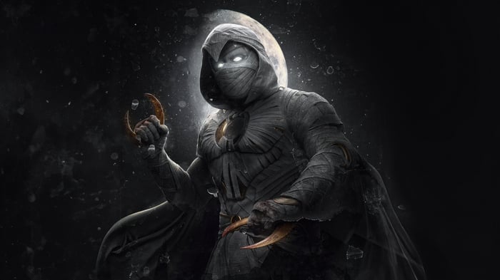 Moon Knight holding crescent darts and a crescent moon symbol